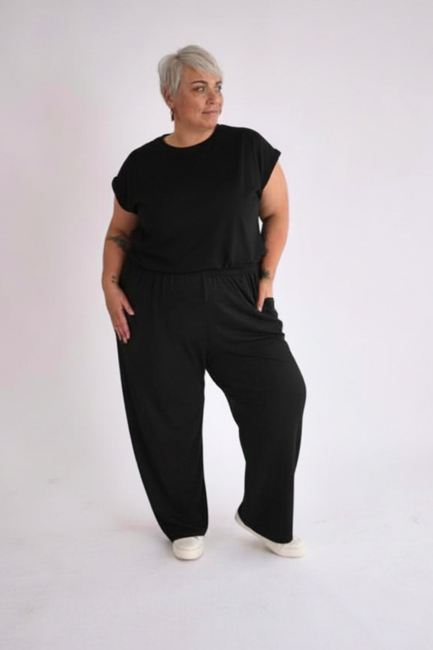 Person wearing a black outfit on a white background